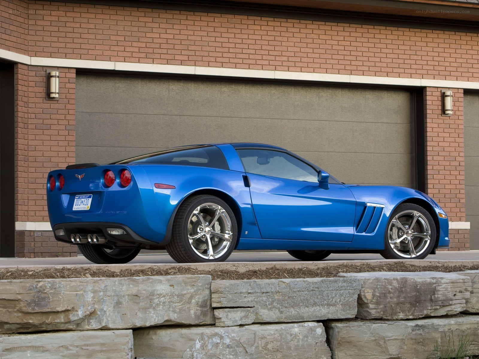 Blue Corvette parked outside garage