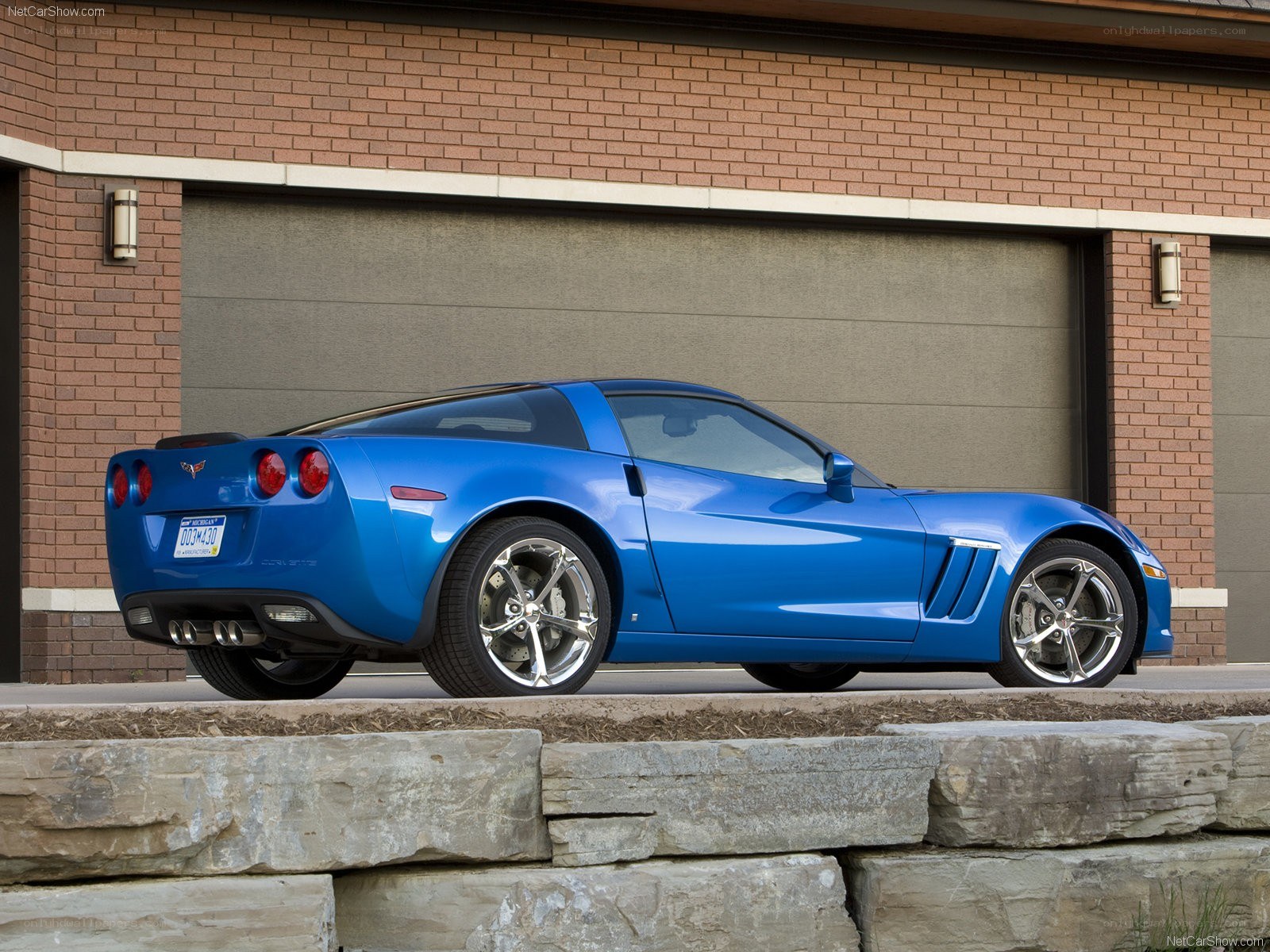 Blue Corvette parked outside garage