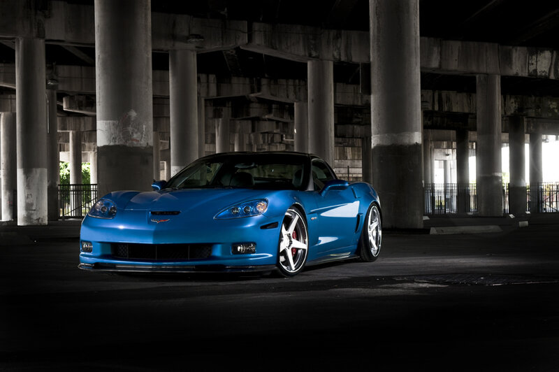 Blue Corvette under highway