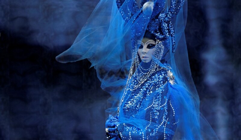 Blue-costumed Figure
