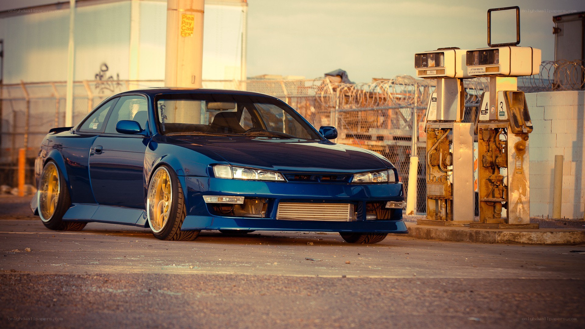 blue coupe at gas station