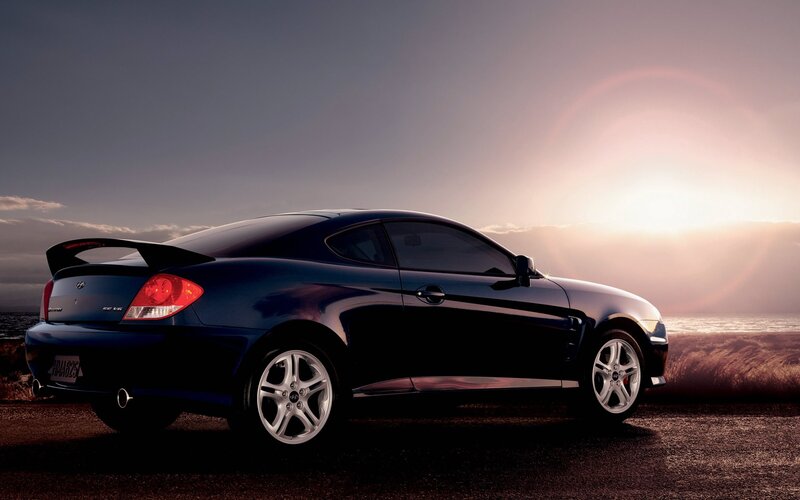 Blue coupe at sunset