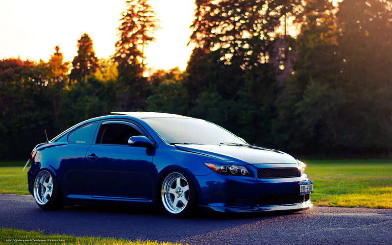 blue coupe at sunset