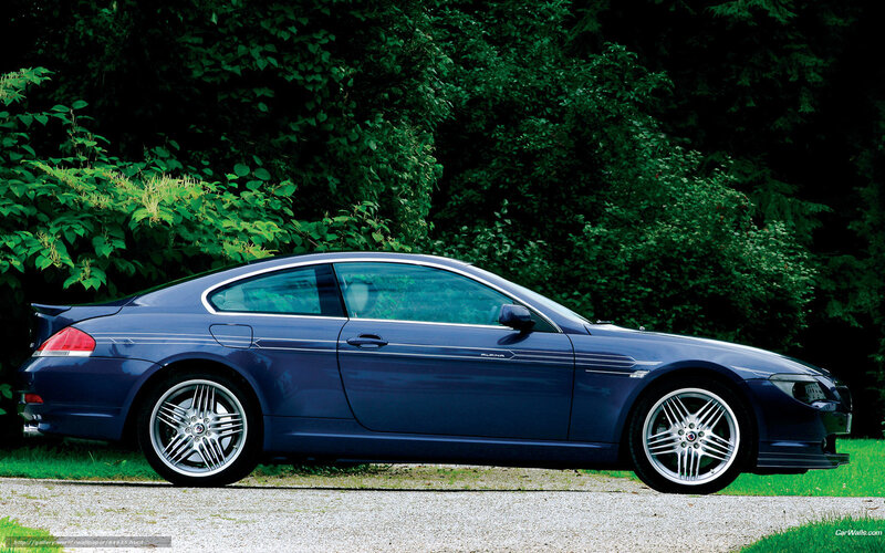 blue coupe car on gravel