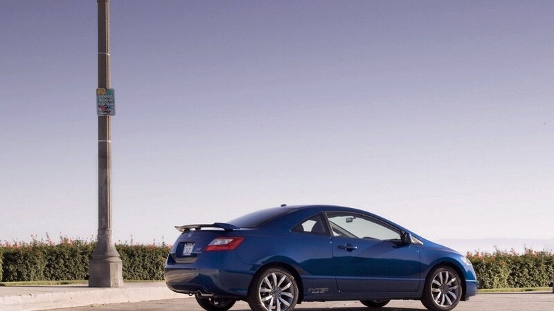 blue coupe parked on street