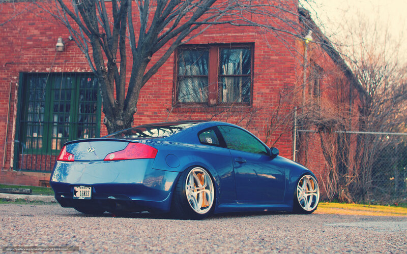 blue coupe parked outside brick building
