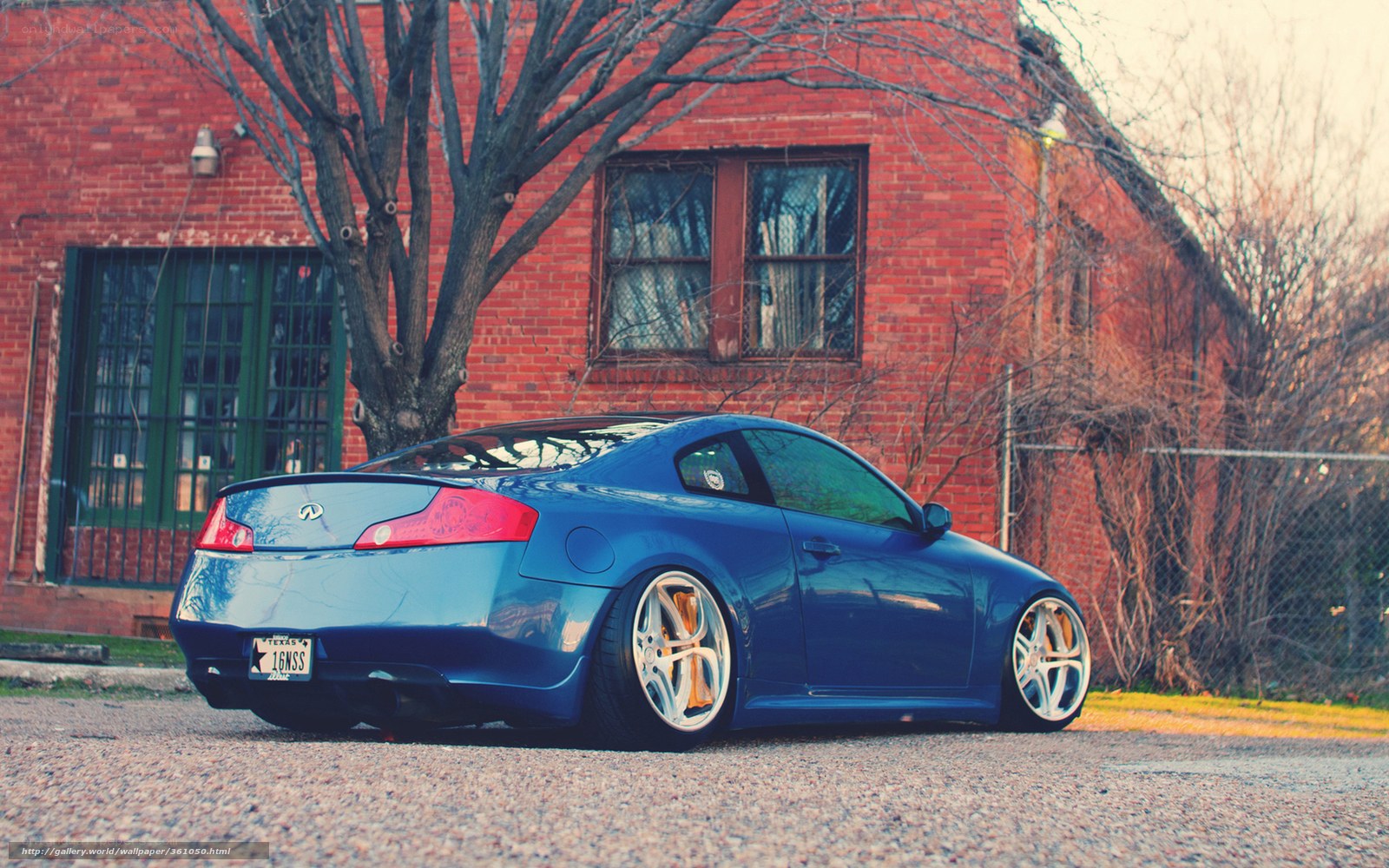 blue coupe parked outside brick building