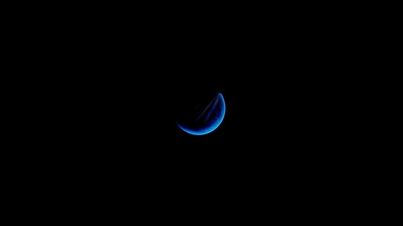 blue crescent in darkness