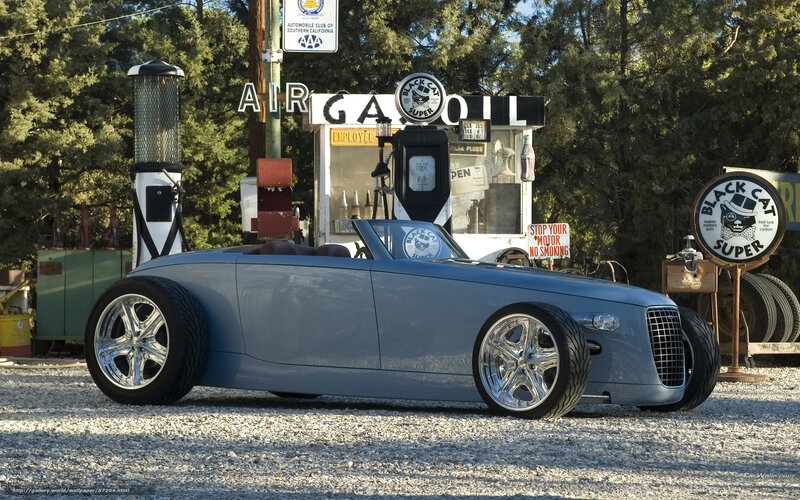 Blue custom car at vintage gas station