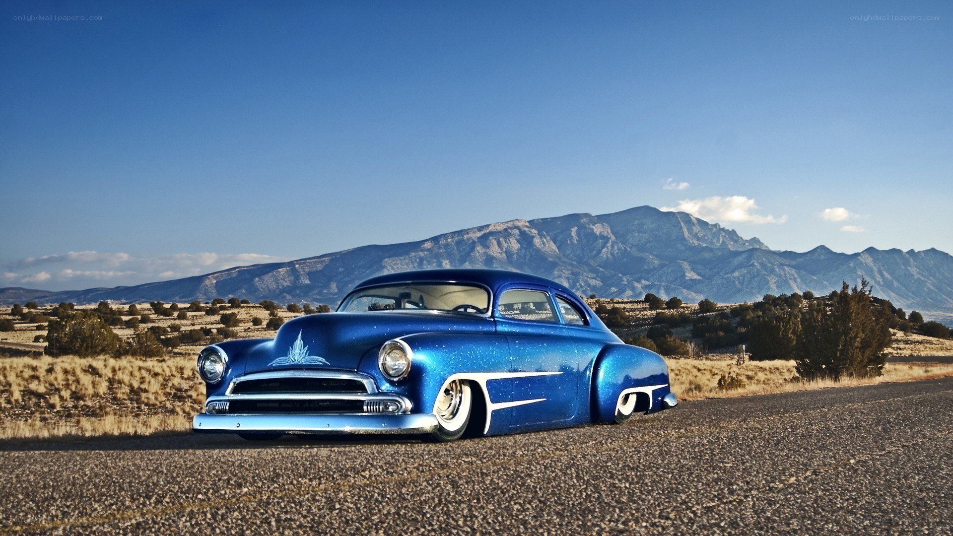 Blue custom car on desert road