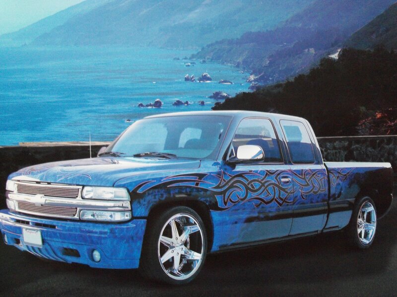 Blue custom pickup truck by coast