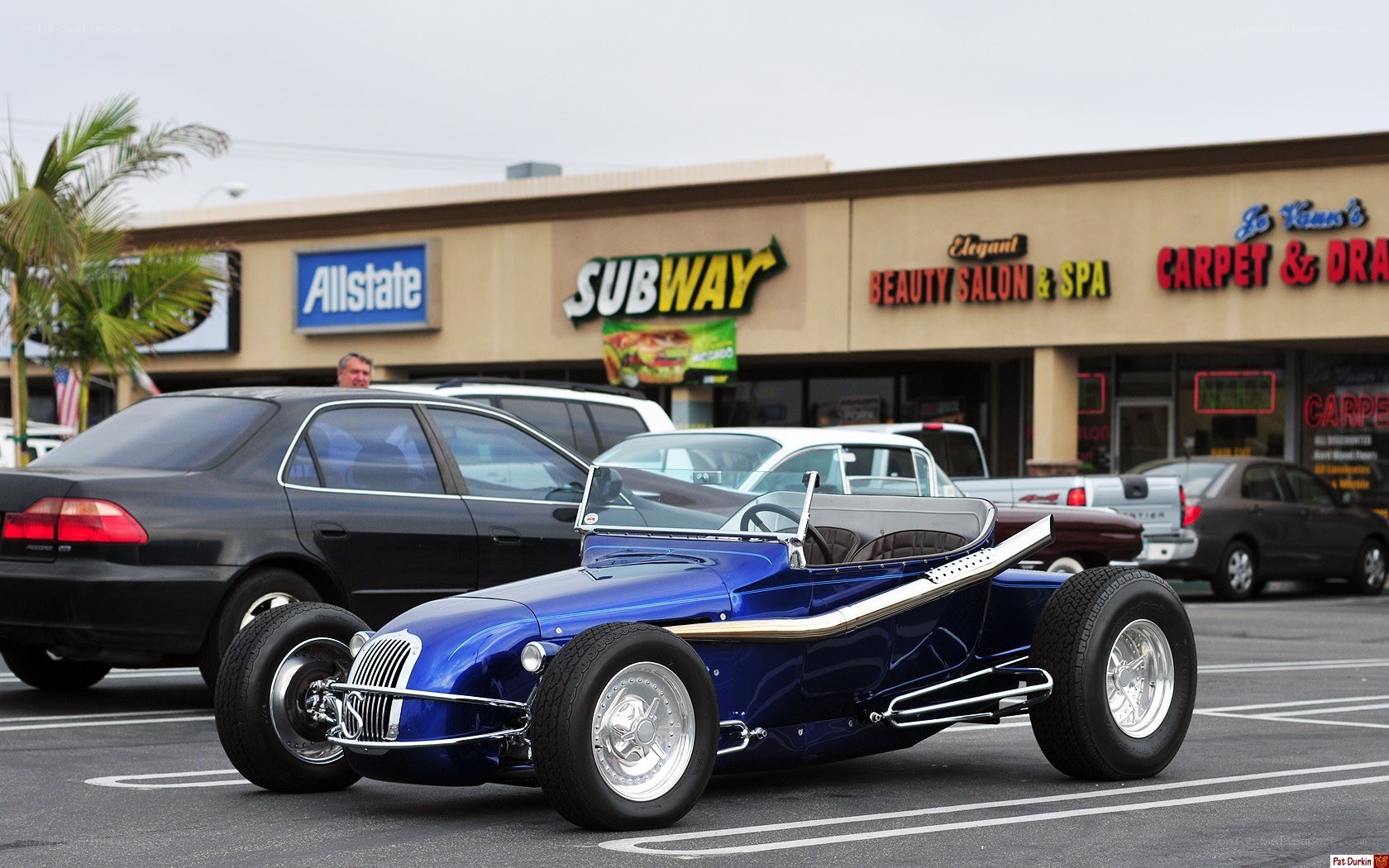 Blue custom roadster in parking lot