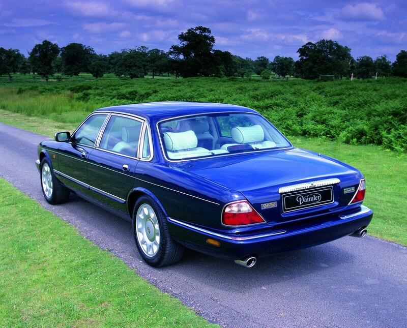 blue daimler sedan on country road