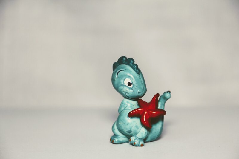 Blue dinosaur holding starfish