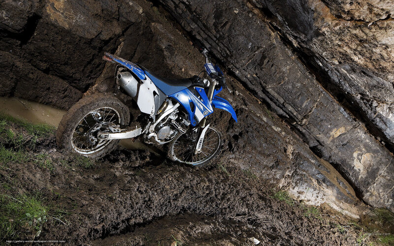 Blue dirt bike in muddy terrain