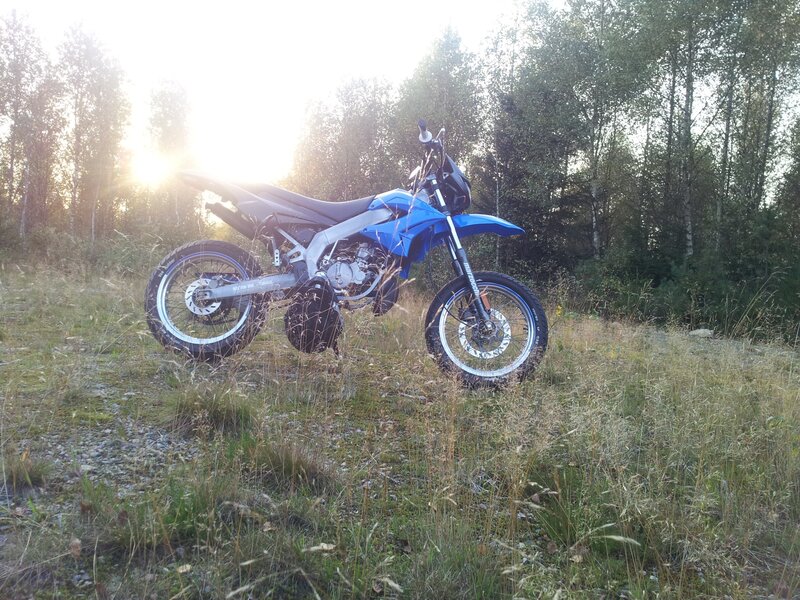 Blue Dirt Bike — Serene, Sunset, Photograph, Grass