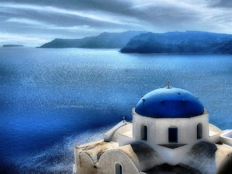 Blue dome church overlooking the sea