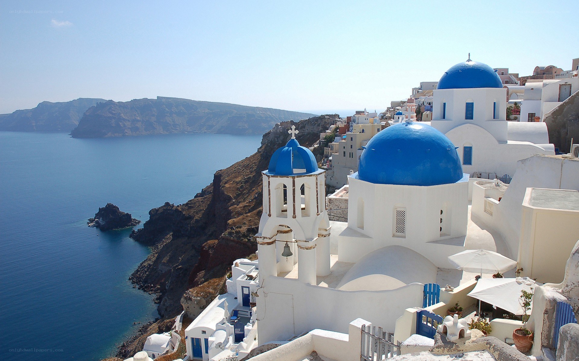 Blue-domed churches on a cliff