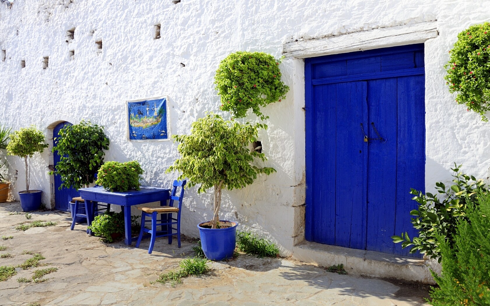Blue door and table in courtyard