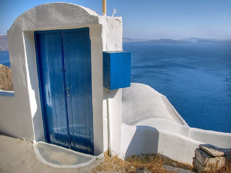 Blue door overlooking the sea