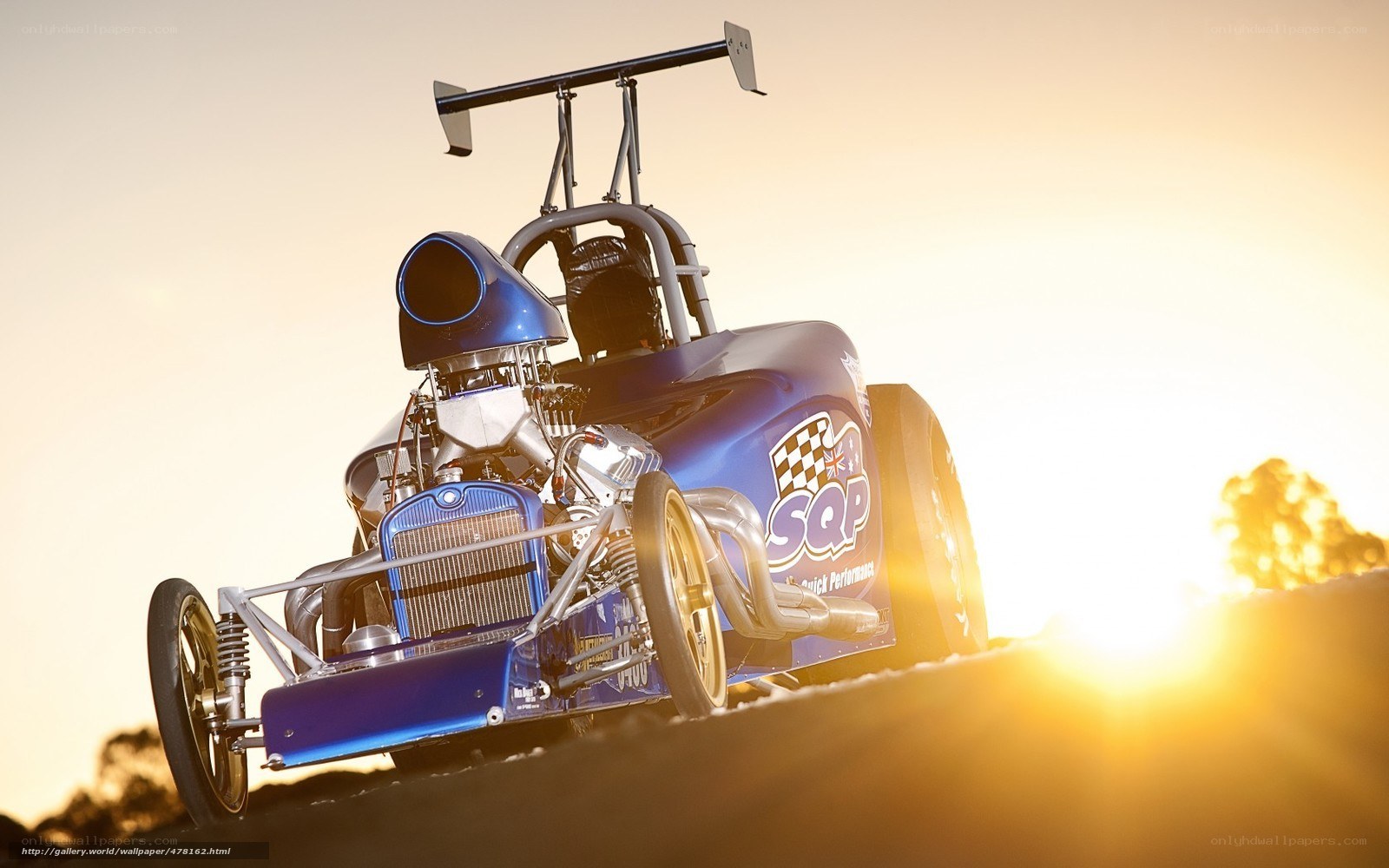 blue drag racing car at sunset