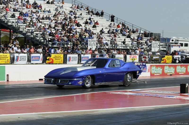 Blue drag racing car on track