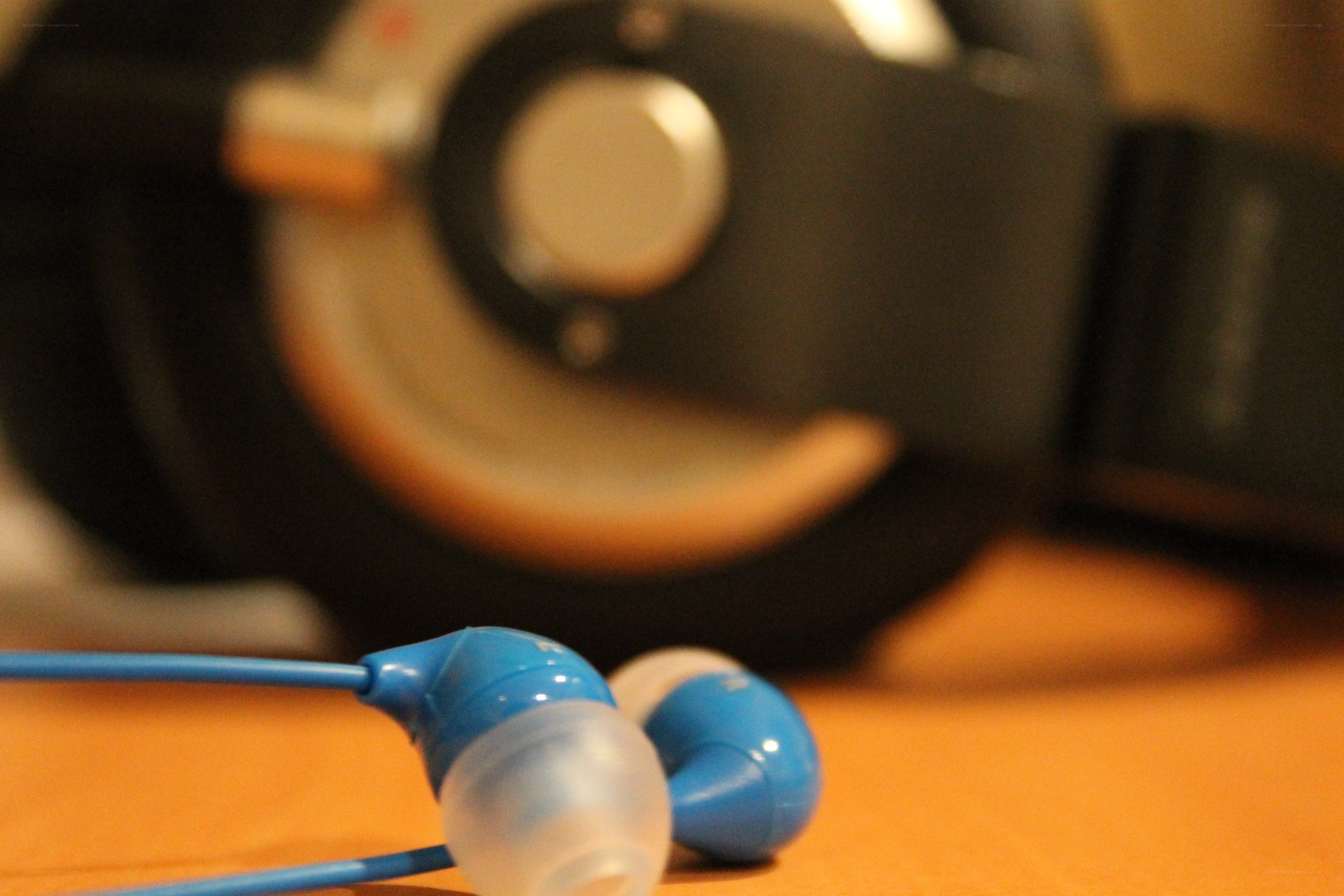 blue earbuds on wooden surface