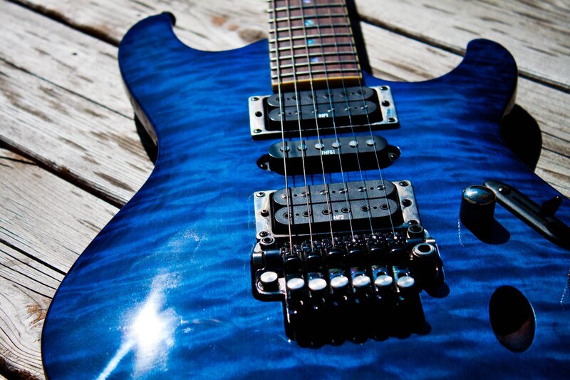 blue electric guitar on wood