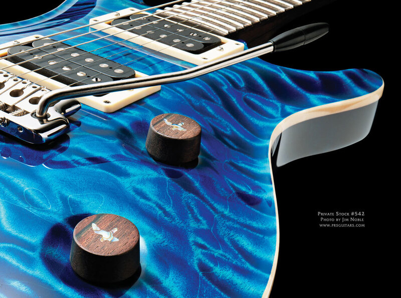 Blue electric guitar with wood knobs