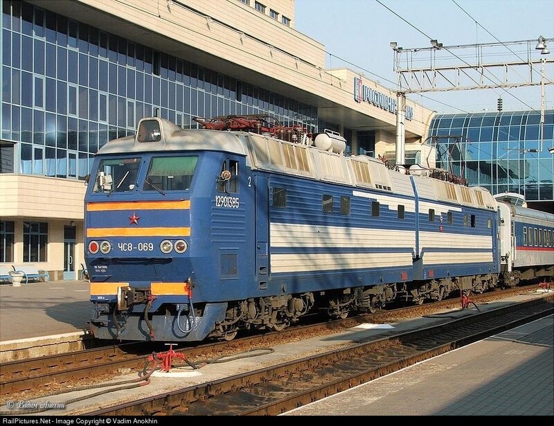 Blue electric locomotive at station