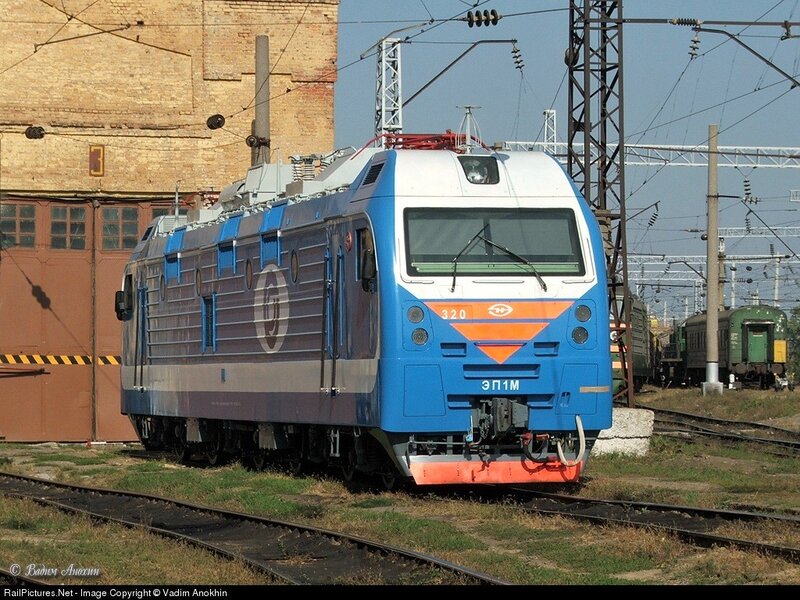 Blue electric locomotive on tracks