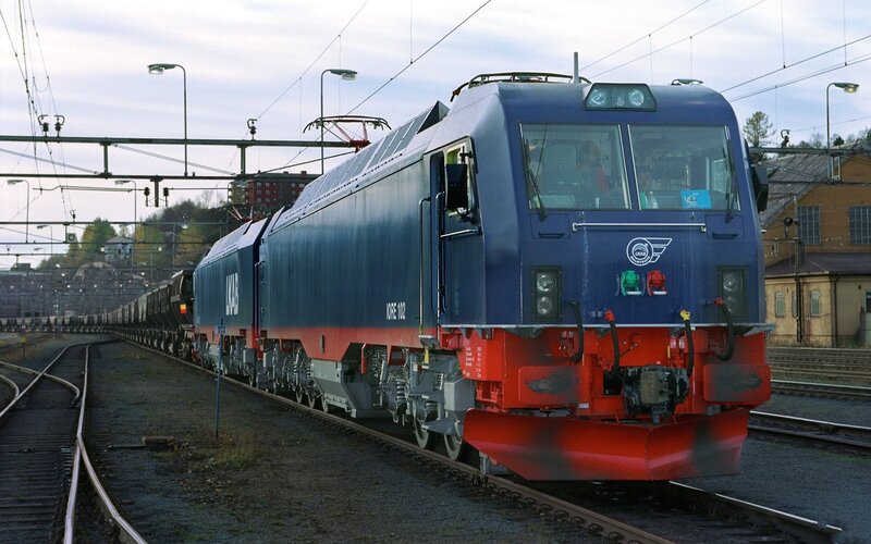 Blue electric locomotive on tracks