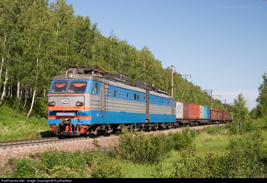 Blue electric locomotive pulling freight
