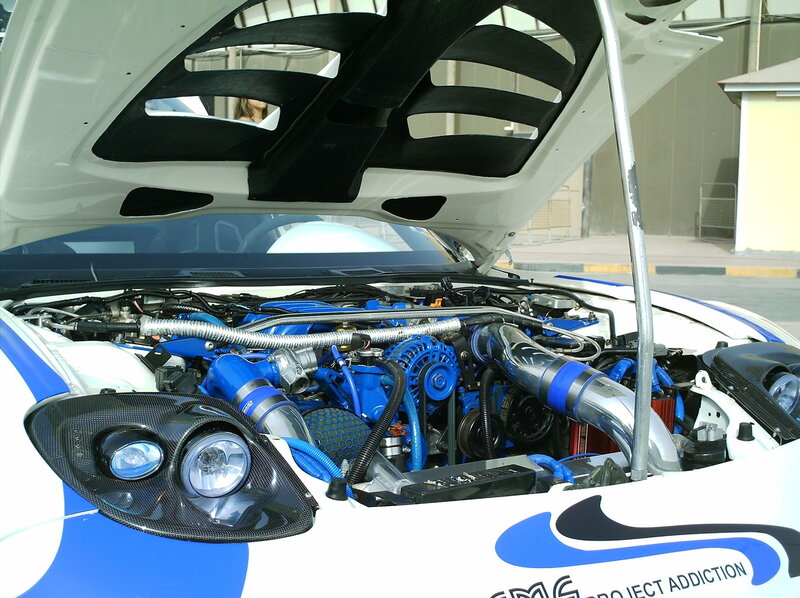 blue engine car with open hood