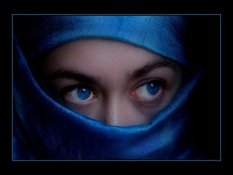 blue-eyed person in blue veil
