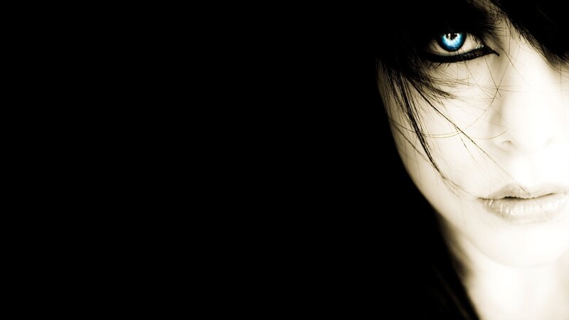 blue-eyed woman in darkness