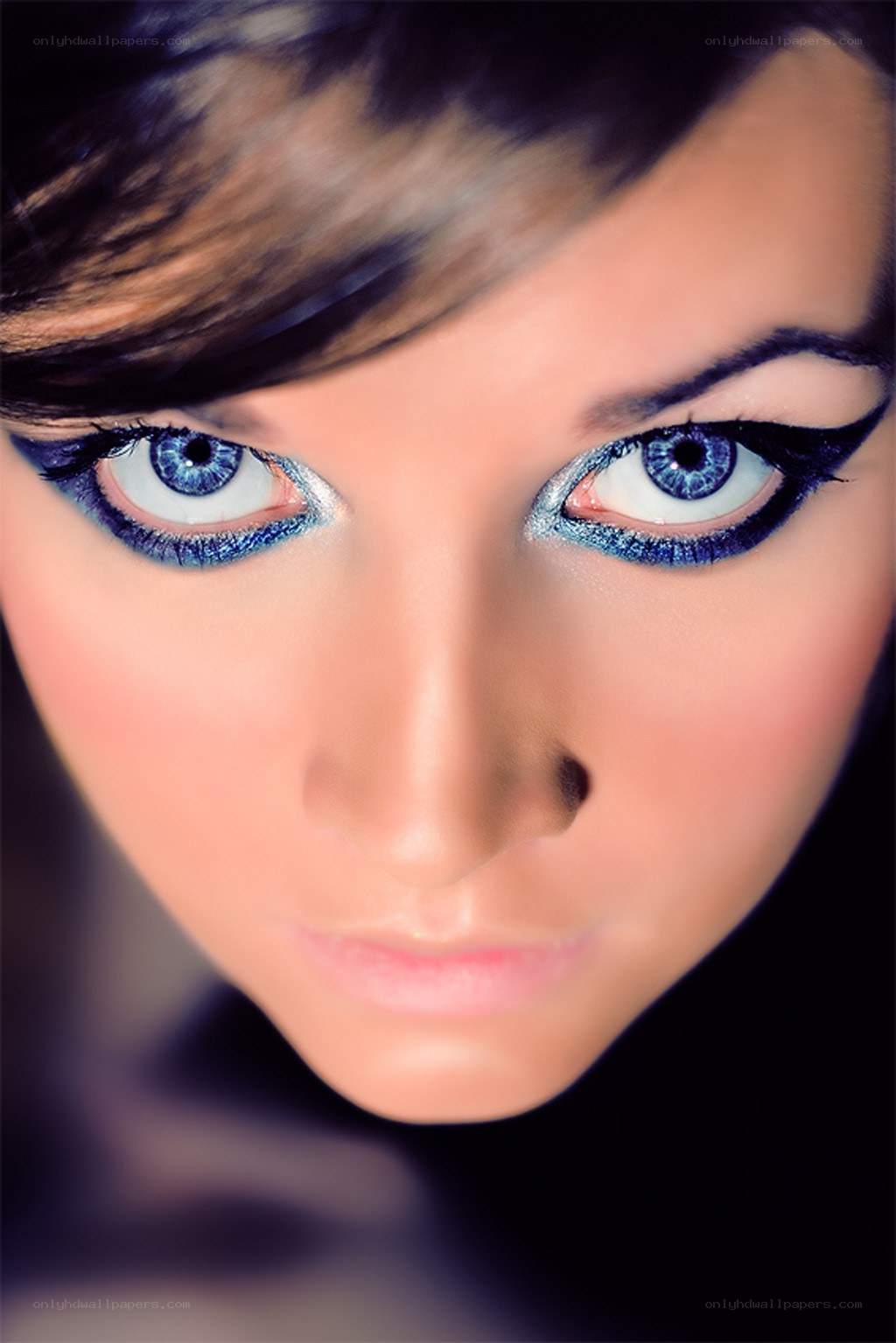 blue-eyed woman with dramatic makeup