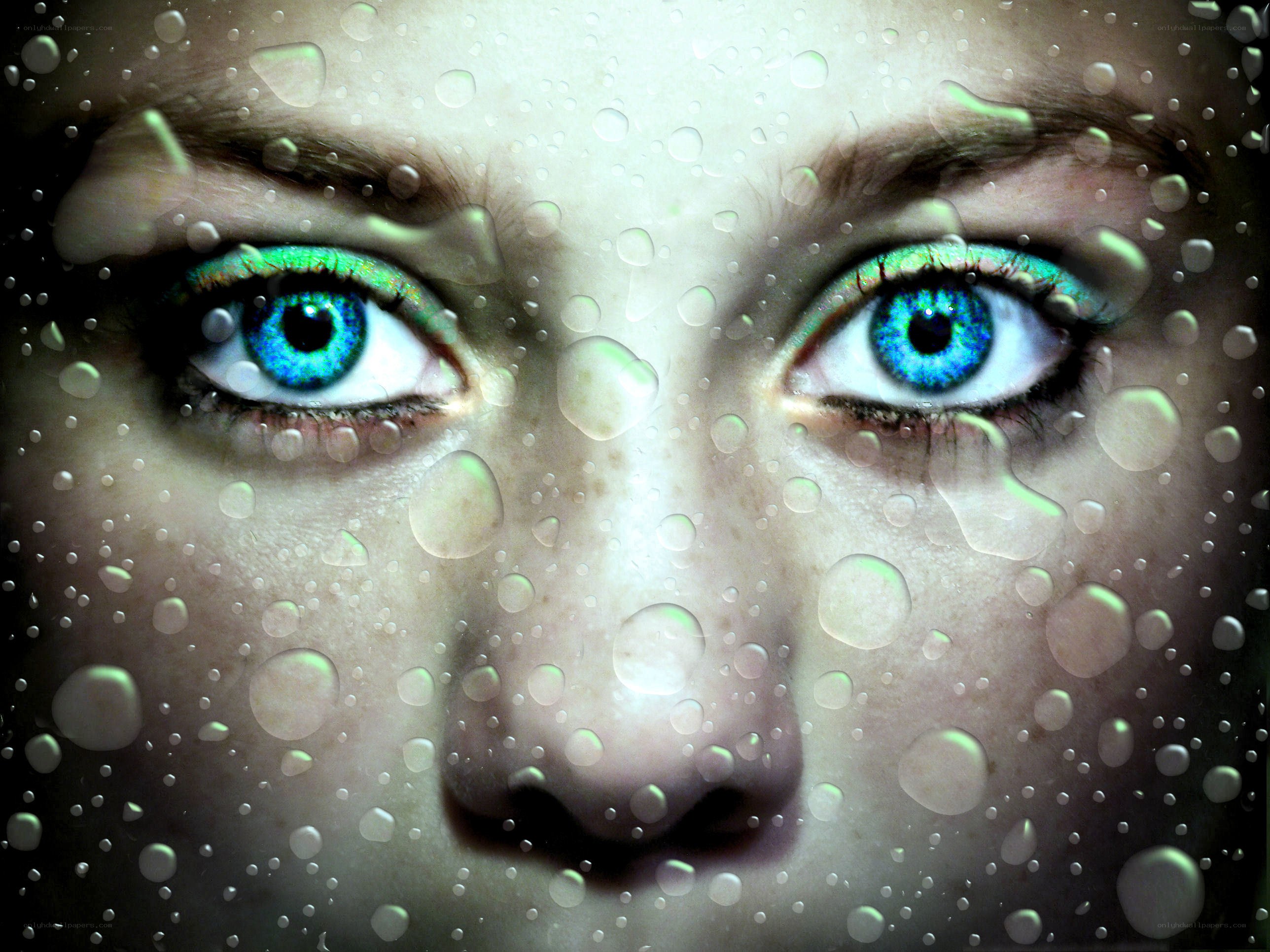 blue eyes behind water droplets
