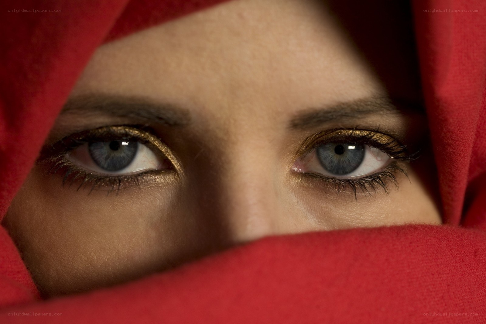 blue eyes under red fabric