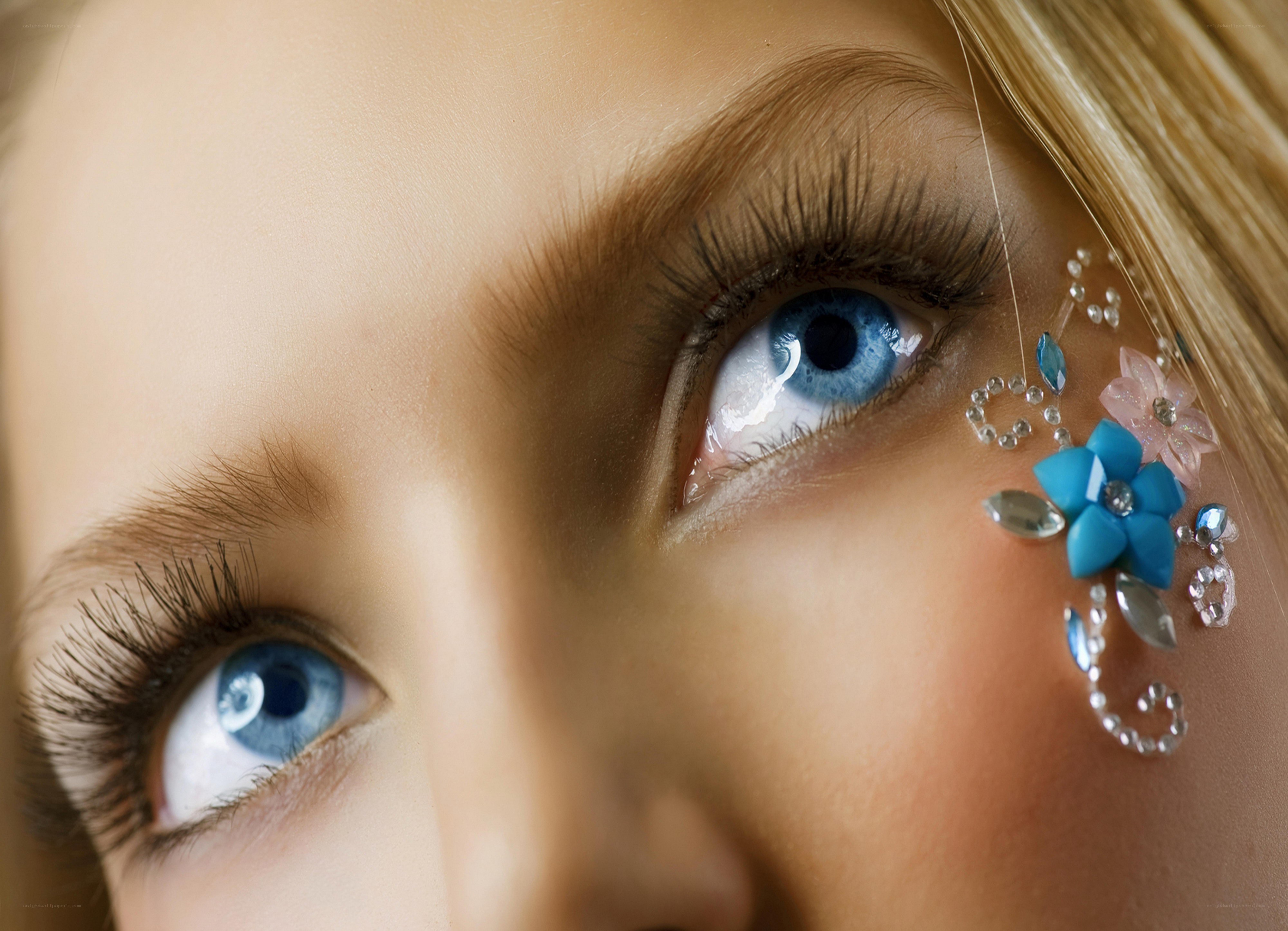 blue eyes with decorative flower