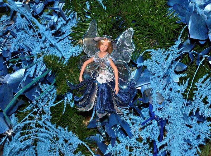 Blue fairy ornament on tree