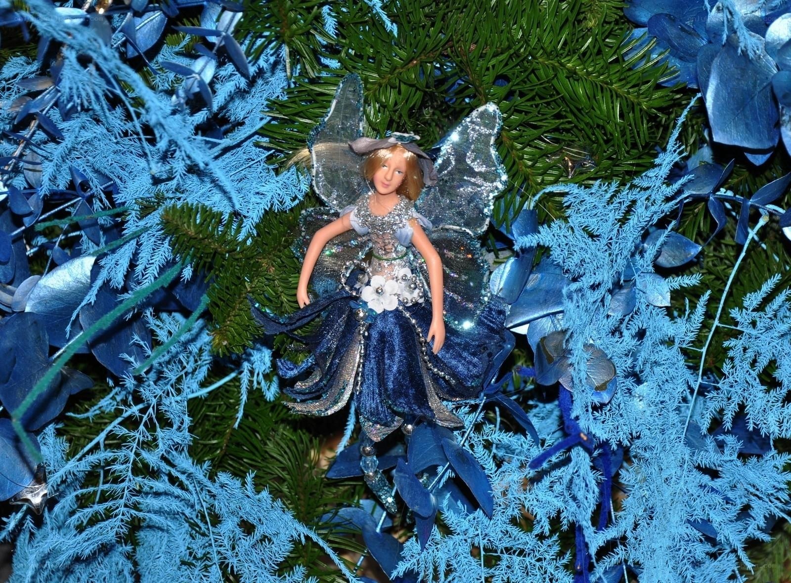 Blue fairy ornament on tree