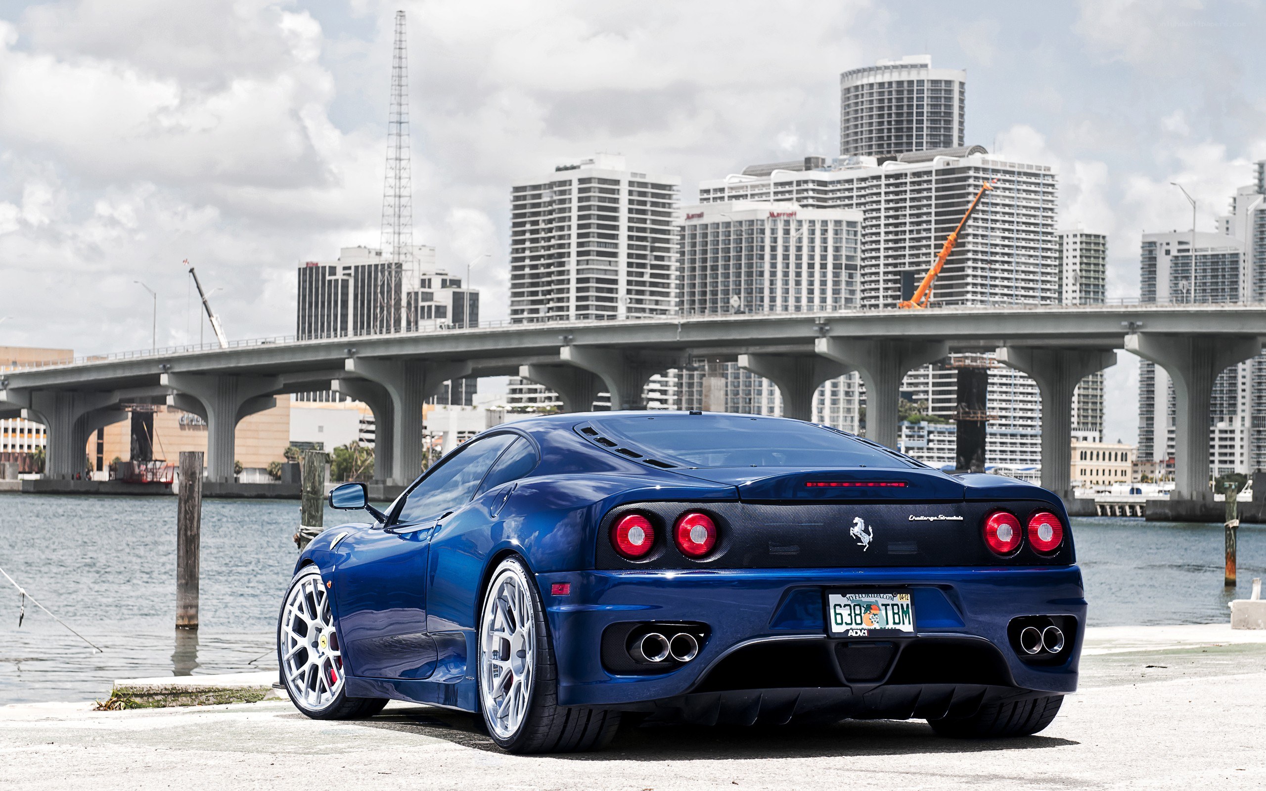 blue ferrari at waterfront