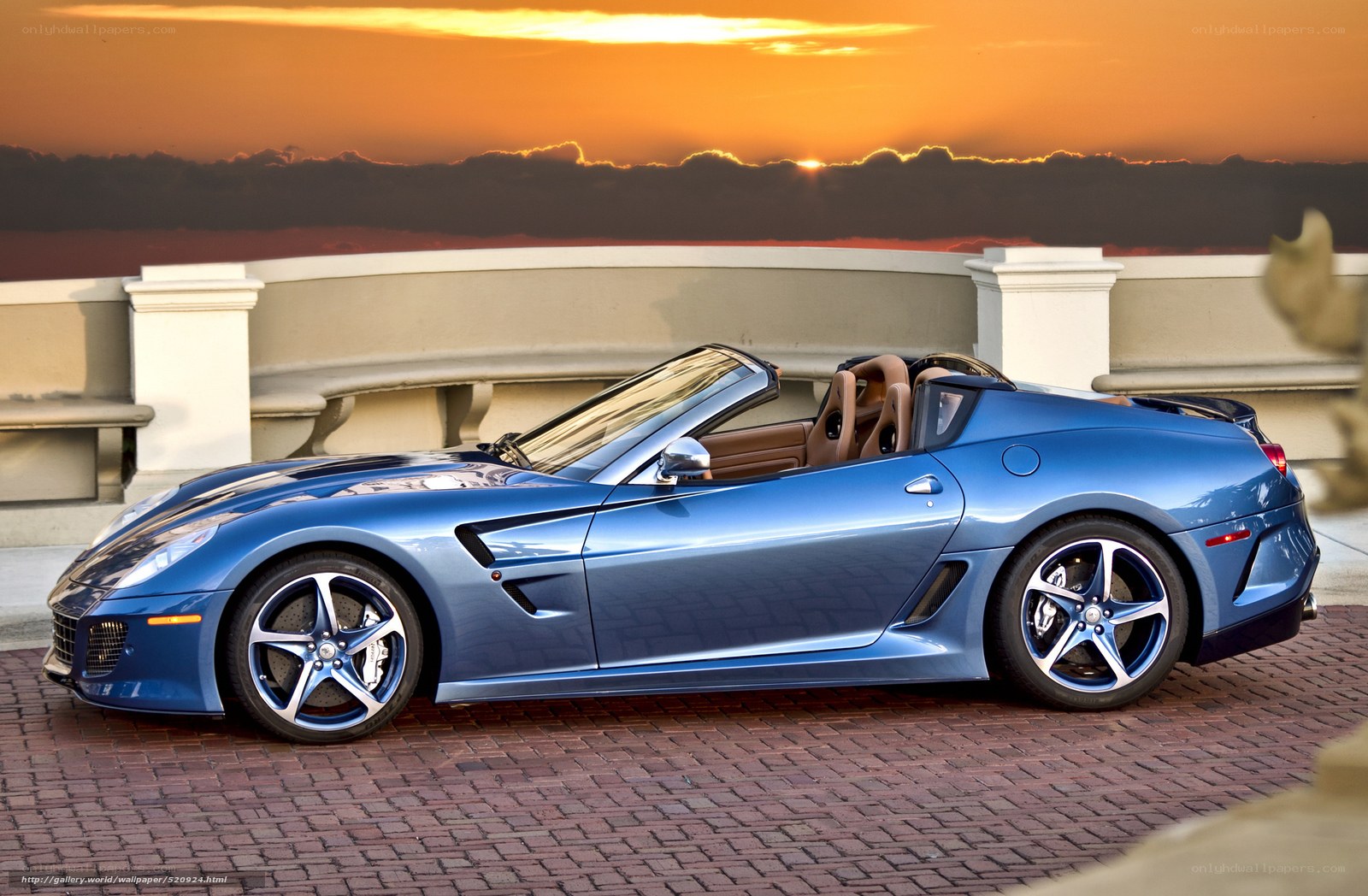 Blue Ferrari convertible at sunset