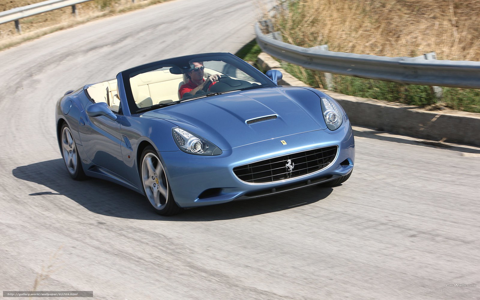 Blue Ferrari convertible on road