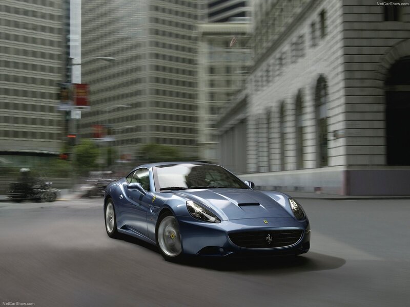 Blue Ferrari driving in city