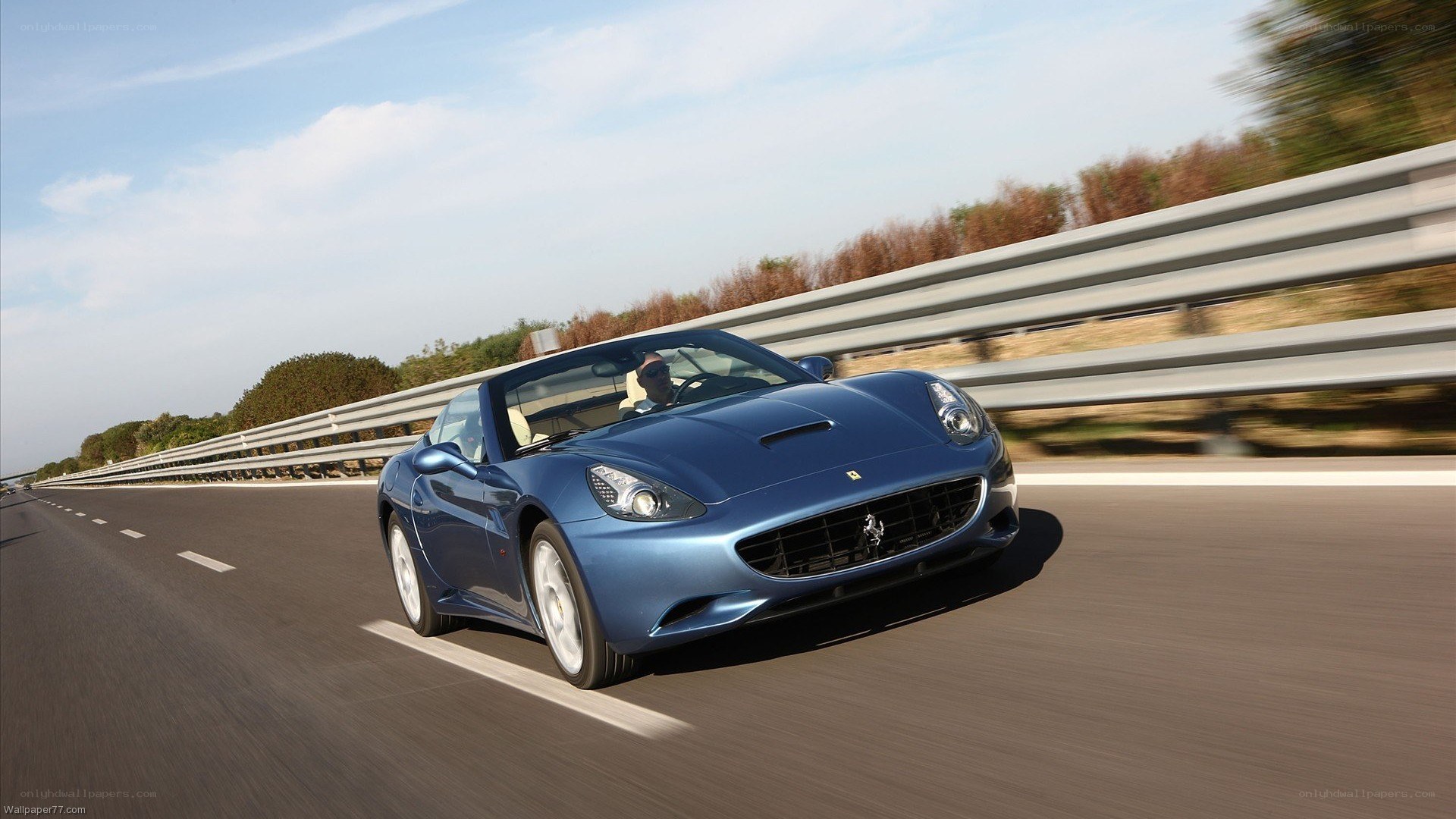 blue ferrari driving on highway