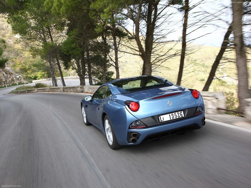 blue ferrari driving on road