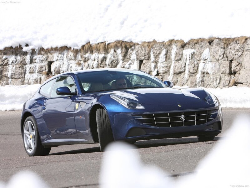 Blue Ferrari driving on snowy road
