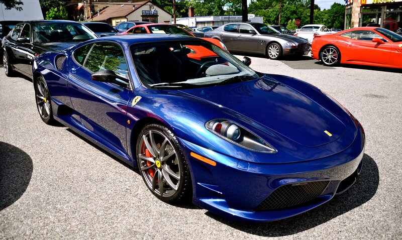 Blue Ferrari in a parking lot